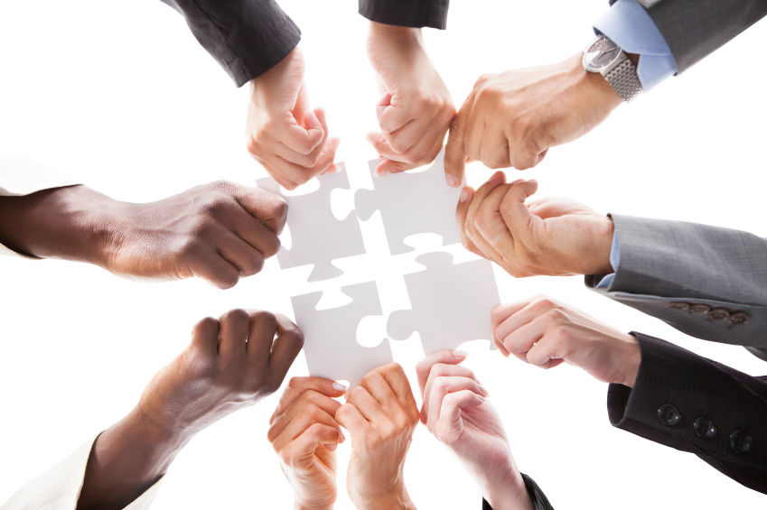 Businesspeople Holding Jigsaw Puzzle